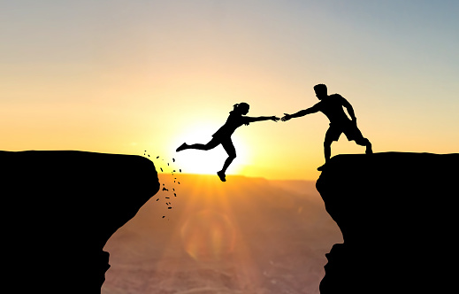 man reach woman help cliff2.jpg